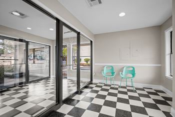a lobby with a checkered floor and glass doors